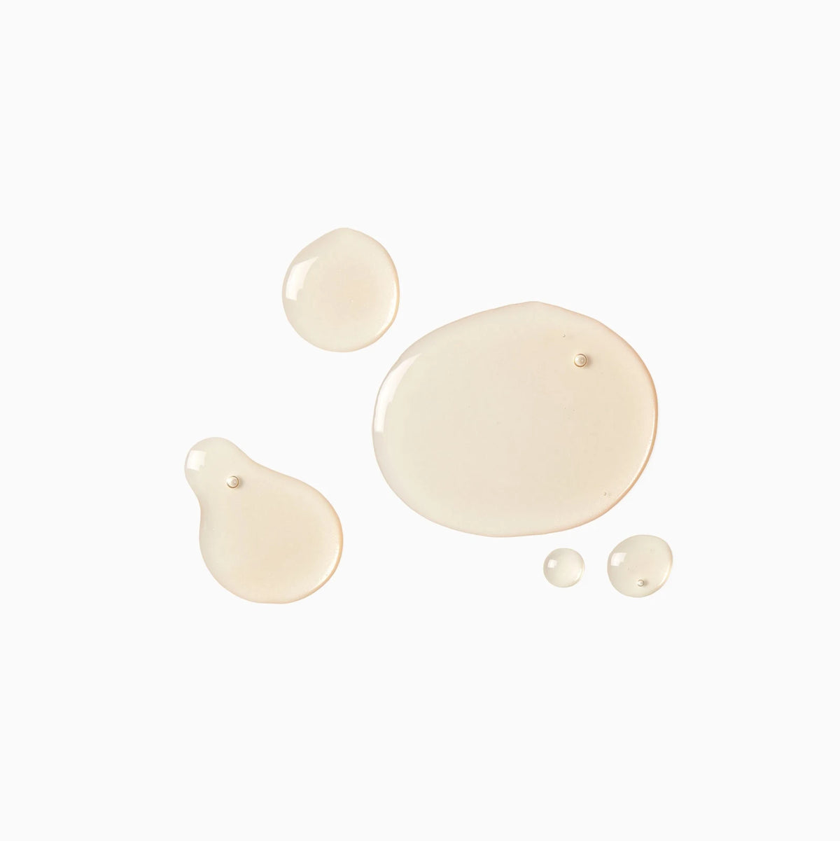 Collection of beige paint droplets on a white background